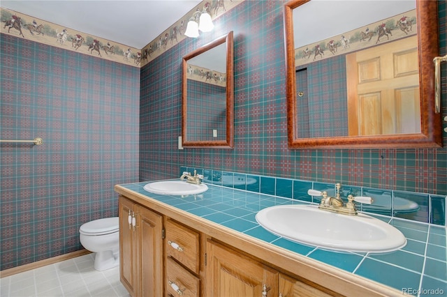 bathroom with vanity, toilet, and tile patterned flooring