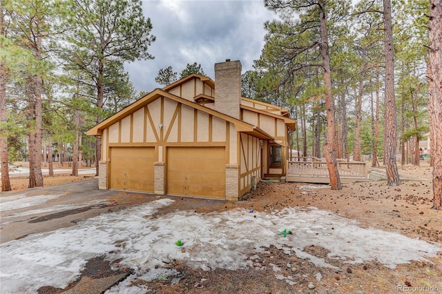 exterior space featuring a wooden deck and a garage