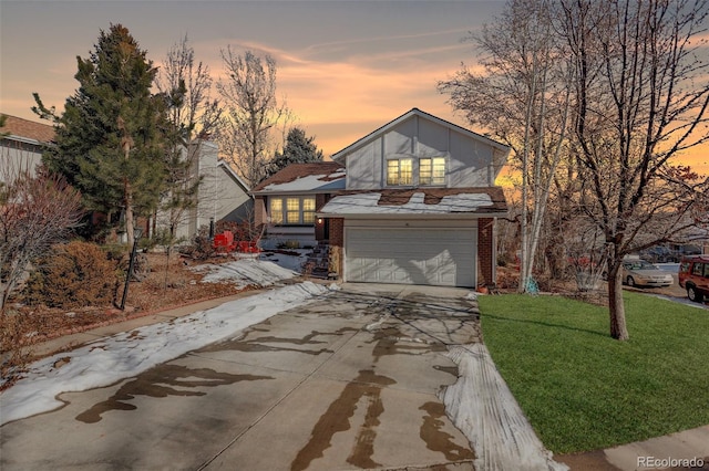 view of front of house with a garage and a lawn