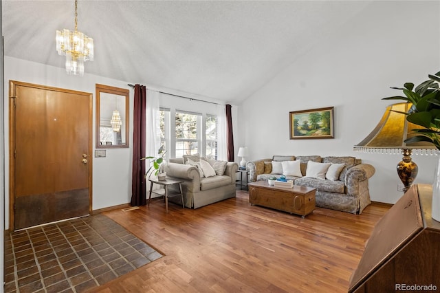 living room with dark hardwood / wood-style flooring, a chandelier, high vaulted ceiling, and a textured ceiling