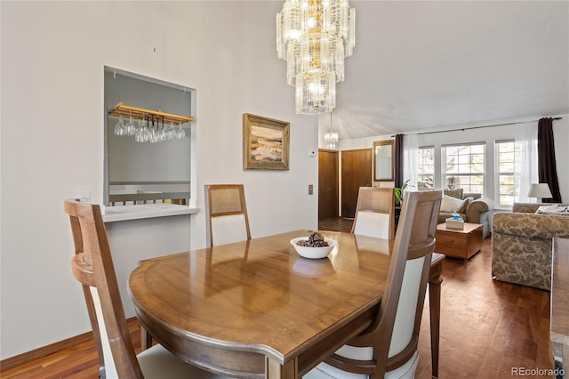 dining area featuring an inviting chandelier and dark hardwood / wood-style floors