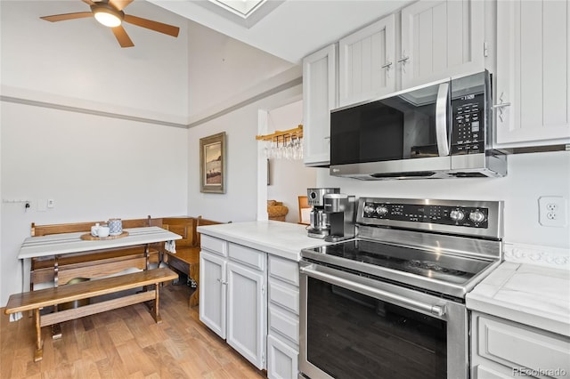 kitchen featuring white cabinetry, ceiling fan, appliances with stainless steel finishes, and light hardwood / wood-style floors