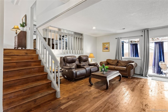 living room featuring hardwood / wood-style flooring and a textured ceiling