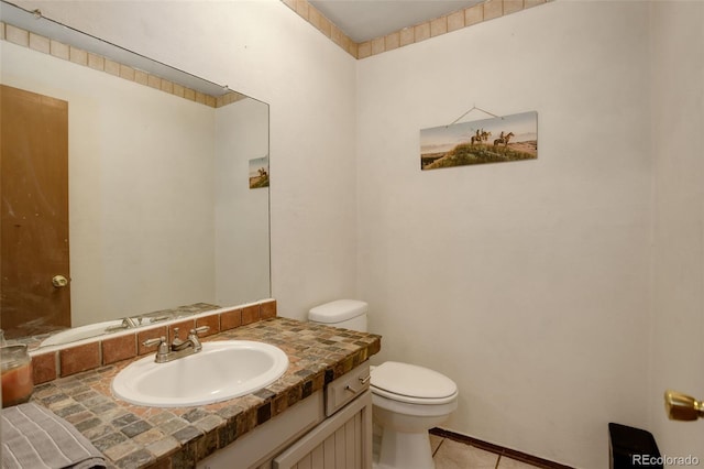 bathroom with vanity, toilet, and tile patterned flooring