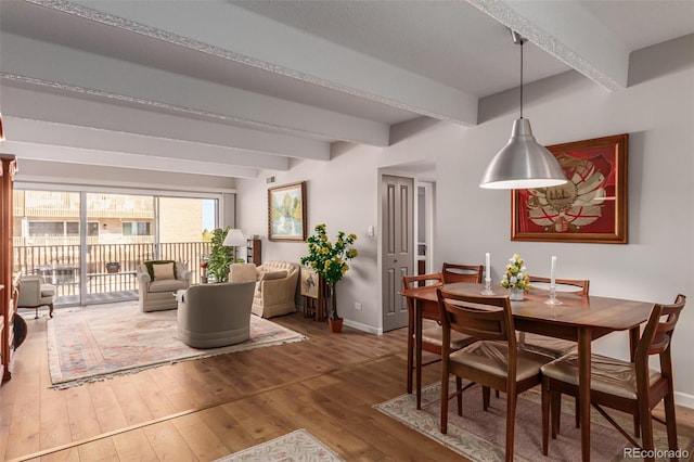 dining area featuring hardwood / wood-style floors and beam ceiling