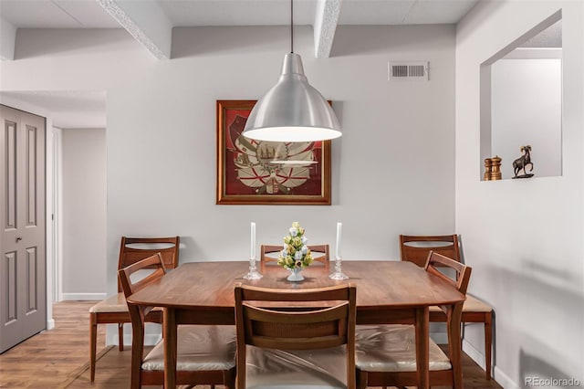 dining space with hardwood / wood-style flooring