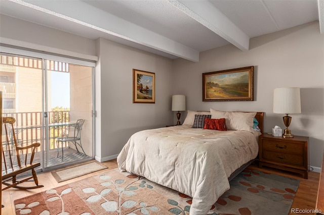 bedroom featuring beamed ceiling, access to exterior, and light wood-type flooring