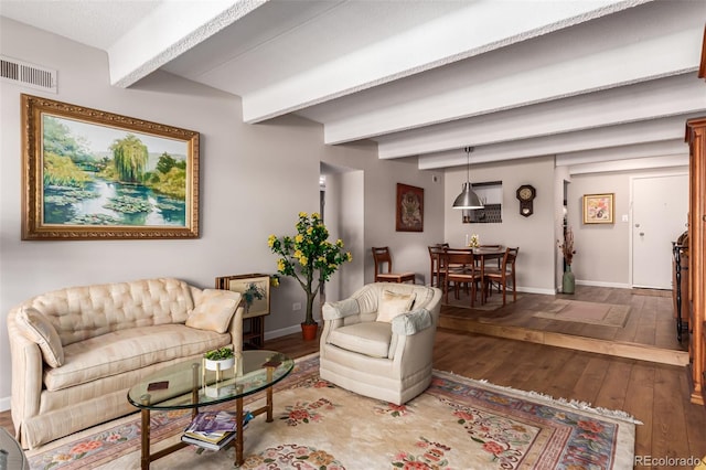 living room featuring hardwood / wood-style flooring and beamed ceiling