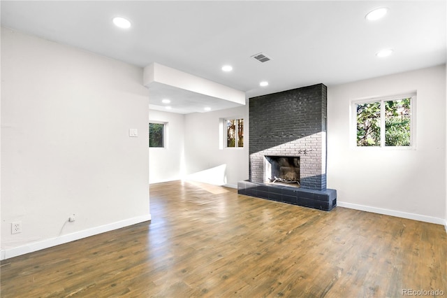 220 S Raleigh St, Denver, CO 80219 - unfurnished living room with plenty of natural light, a fireplace, wood finished floors, and recessed lighting