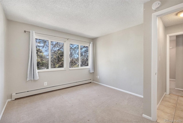 carpeted empty room with baseboards, a textured ceiling, and baseboard heating