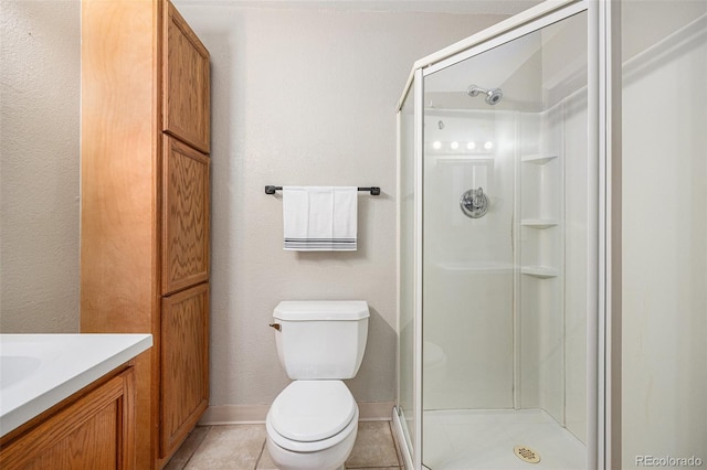 bathroom with toilet, a stall shower, tile patterned flooring, and vanity