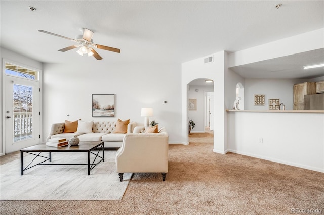 living room with light carpet and ceiling fan