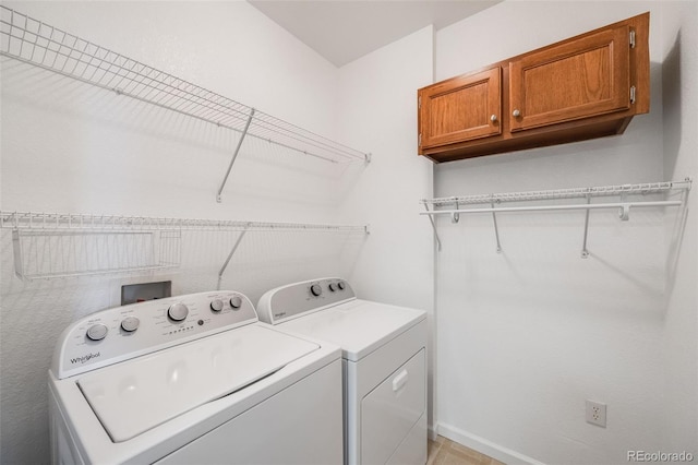 laundry area with washer and dryer, cabinet space, and baseboards