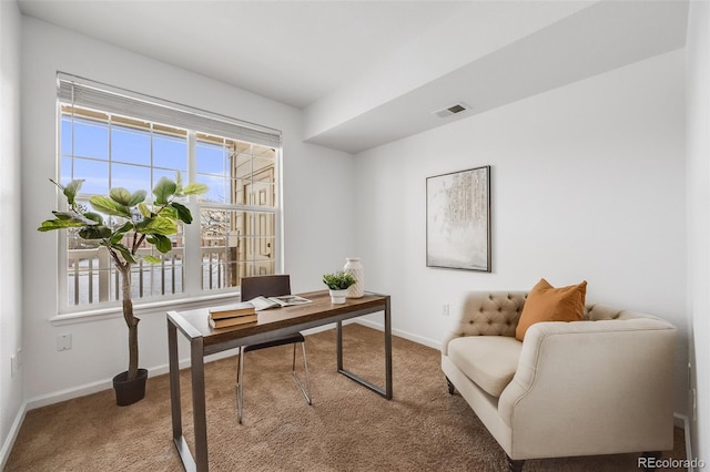 office space featuring carpet floors, visible vents, and baseboards