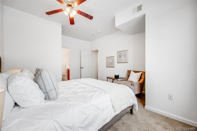 carpeted bedroom featuring visible vents, connected bathroom, baseboards, and ceiling fan