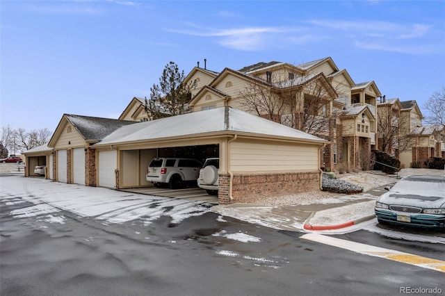 view of front of home featuring brick siding and community garages