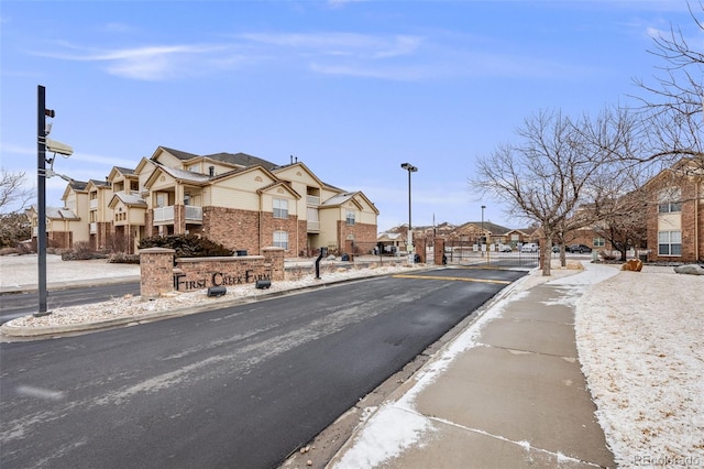 view of street featuring a residential view and curbs