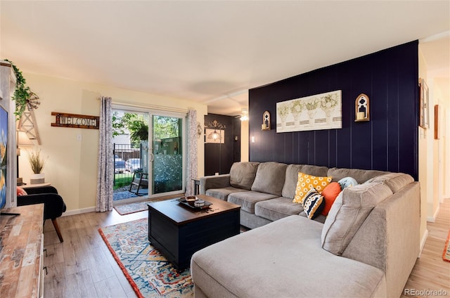 2325 S Linden Ct Unit 101, Denver, CO 80222 - living room featuring an accent wall, light wood-style flooring, and baseboards