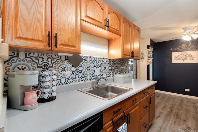 2325 S Linden Ct Unit 101, Denver, CO 80222 - kitchen featuring a sink, a ceiling fan, light countertops, light wood-type flooring, and decorative backsplash