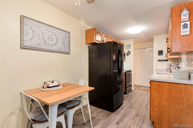 2325 S Linden Ct Unit 101, Denver, CO 80222 - kitchen featuring freestanding refrigerator, light wood-style flooring, electric range oven, a sink, and light countertops