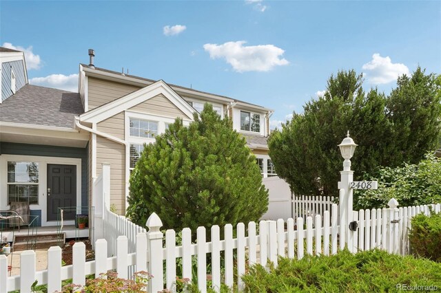 2408 Concord Cir, Lafayette, CO 80026 - view of front of home featuring a fenced front yard and a shingled roof