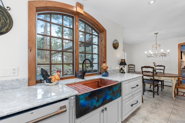 689 Red Deer Rd, Franktown, CO 80116 - kitchen featuring dishwashing machine, a chandelier, white cabinetry, hanging light fixtures, and a sink