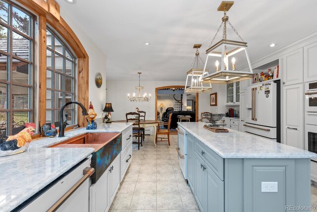 689 Red Deer Rd, Franktown, CO 80116 - kitchen featuring a chandelier, white appliances, white cabinets, a center island, and light stone countertops