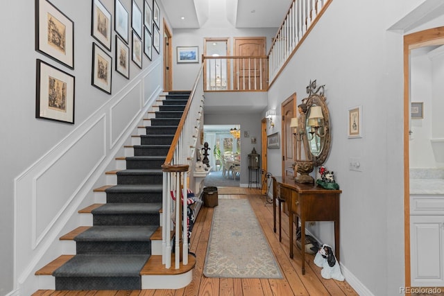 689 Red Deer Rd, Franktown, CO 80116 - stairs with hardwood / wood-style flooring and a towering ceiling