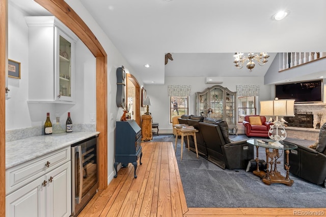 689 Red Deer Rd, Franktown, CO 80116 - living room with wine cooler, a dry bar, light wood-type flooring, a chandelier, and recessed lighting