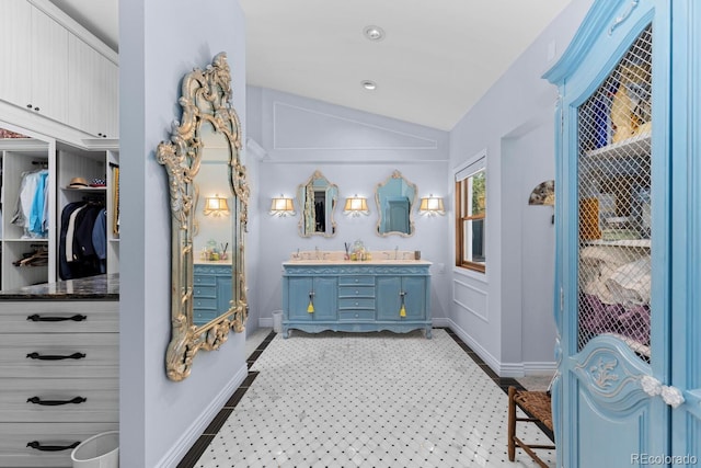 689 Red Deer Rd, Franktown, CO 80116 - full bath featuring vaulted ceiling, double vanity, and baseboards