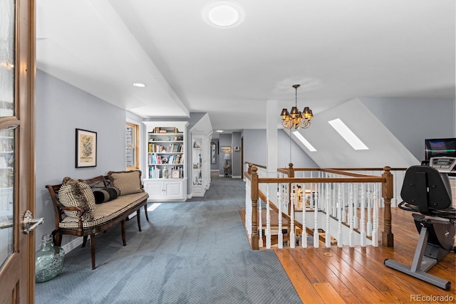 689 Red Deer Rd, Franktown, CO 80116 - hallway with a skylight, an upstairs landing, built in features, hardwood / wood-style floors, and a chandelier