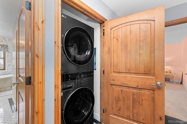 689 Red Deer Rd, Franktown, CO 80116 - laundry area with stacked washer and clothes dryer and baseboards