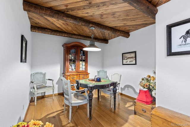 689 Red Deer Rd, Franktown, CO 80116 - dining area with wood finished floors, wooden ceiling with exposed beams, and baseboards