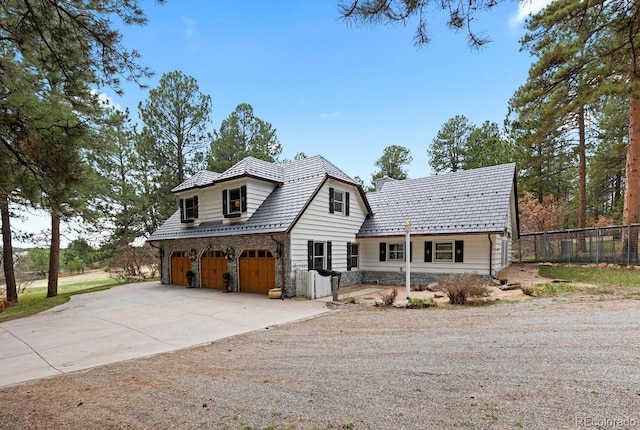 689 Red Deer Rd, Franktown, CO 80116 - view of front of property featuring a garage, stone siding, and concrete driveway