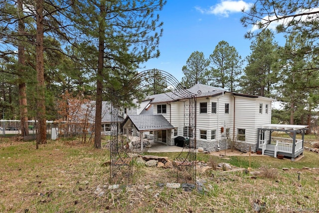 689 Red Deer Rd, Franktown, CO 80116 - rear view of property featuring a patio area, stone siding, a pergola, and a deck