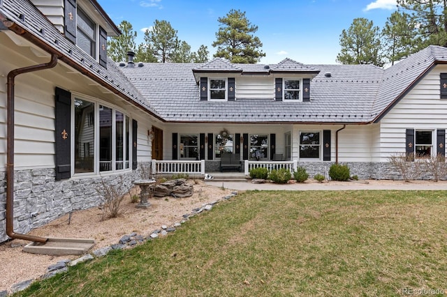 689 Red Deer Rd, Franktown, CO 80116 - view of front of house with stone siding, a porch, and a front lawn