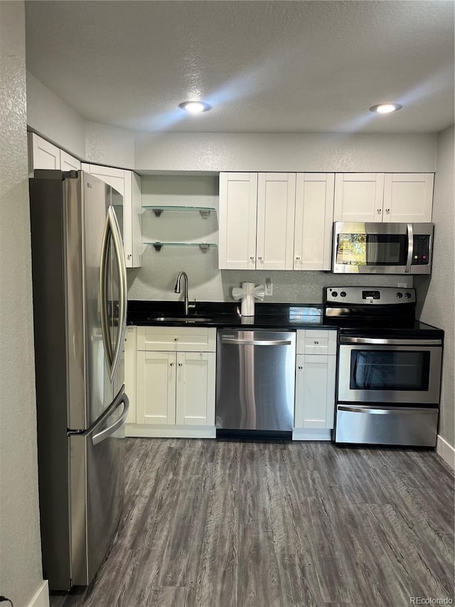 4899 S Dudley St Unit 1E, Littleton, CO 80123 - kitchen featuring appliances with stainless steel finishes, a sink, open shelves, and white cabinets