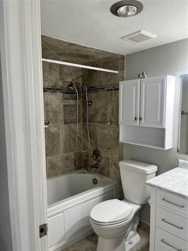 4899 S Dudley St Unit 1E, Littleton, CO 80123 - bathroom featuring toilet, vanity,  shower combination, a textured ceiling, and a textured wall
