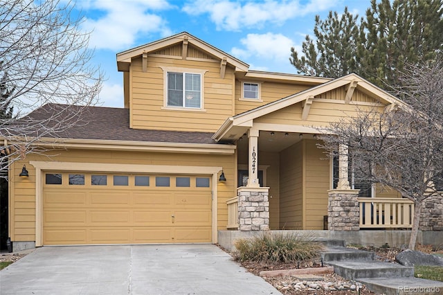 craftsman-style home with a porch, concrete driveway, and an attached garage