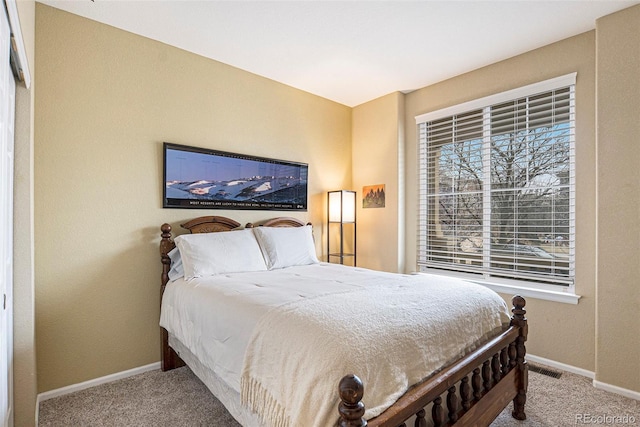 carpeted bedroom featuring visible vents and baseboards