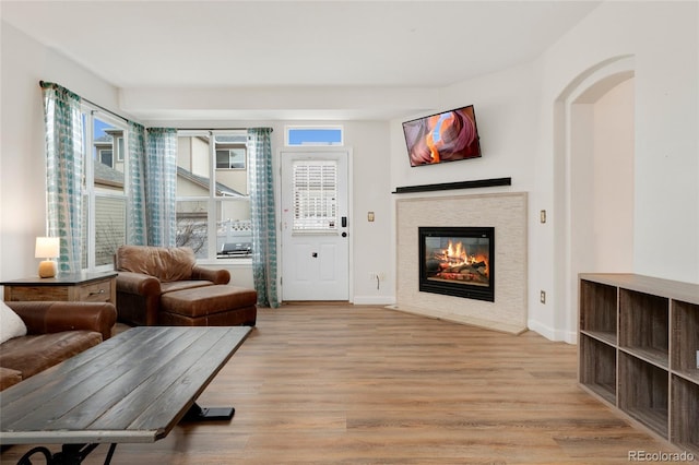 7860 E Ellsworth Ave, Denver, CO 80230 - living room featuring a fireplace with flush hearth, light wood finished floors, and baseboards