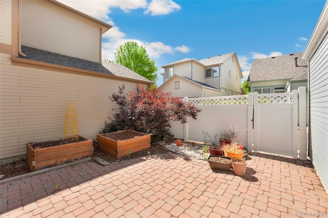 7860 E Ellsworth Ave, Denver, CO 80230 - view of patio featuring a vegetable garden and a gate