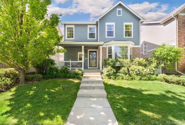 7860 E Ellsworth Ave, Denver, CO 80230 - traditional home featuring covered porch, a front yard, and brick siding