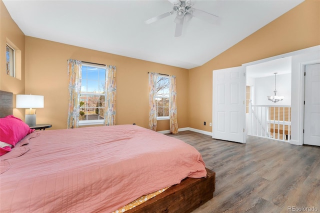 7860 E Ellsworth Ave, Denver, CO 80230 - bedroom featuring wood finished floors, lofted ceiling, a chandelier, baseboards, and a ceiling fan