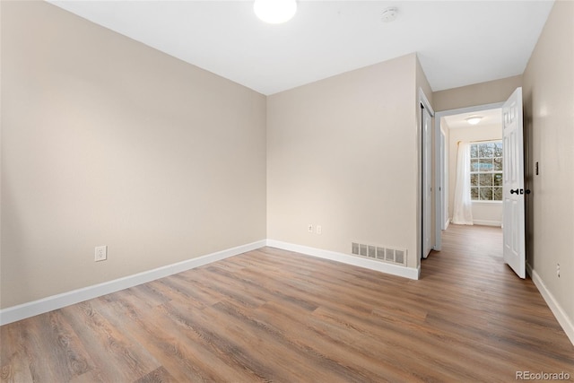 7860 E Ellsworth Ave, Denver, CO 80230 - empty room featuring baseboards, wood finished floors, and a smoke detector