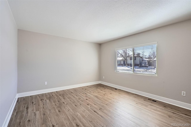 unfurnished room with wood-type flooring