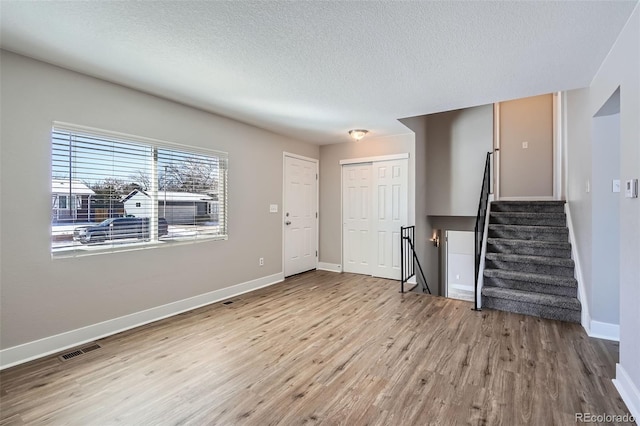 interior space featuring light hardwood / wood-style floors and a textured ceiling