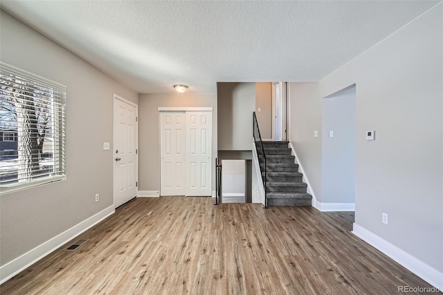 interior space featuring light hardwood / wood-style floors and a textured ceiling