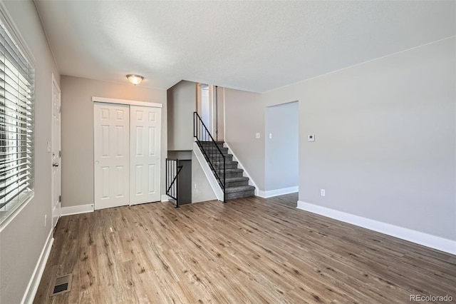 spare room with a healthy amount of sunlight and light wood-type flooring