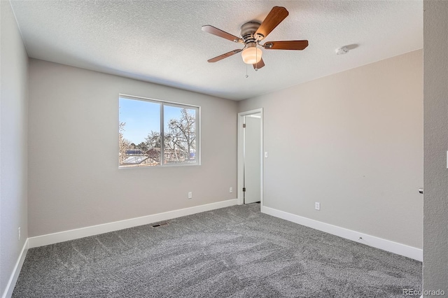 carpeted spare room with ceiling fan and a textured ceiling